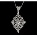 A diamond pendant of pierced foliate design to a 14k white gold mount, the central stone 0.