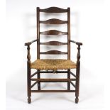 An ash ladderback armchair with rush seat