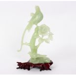 A jade carving of birds in flowering branches, on a stand,