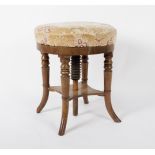 A circular piano stool, with adjustable top on turned legs,