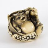 A Japanese ivory netsuke, carved a badger and a hare, Meiji period, circa 1890, 3.