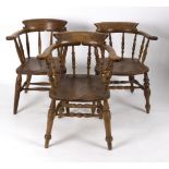 Three elbow chairs with dished elm seats