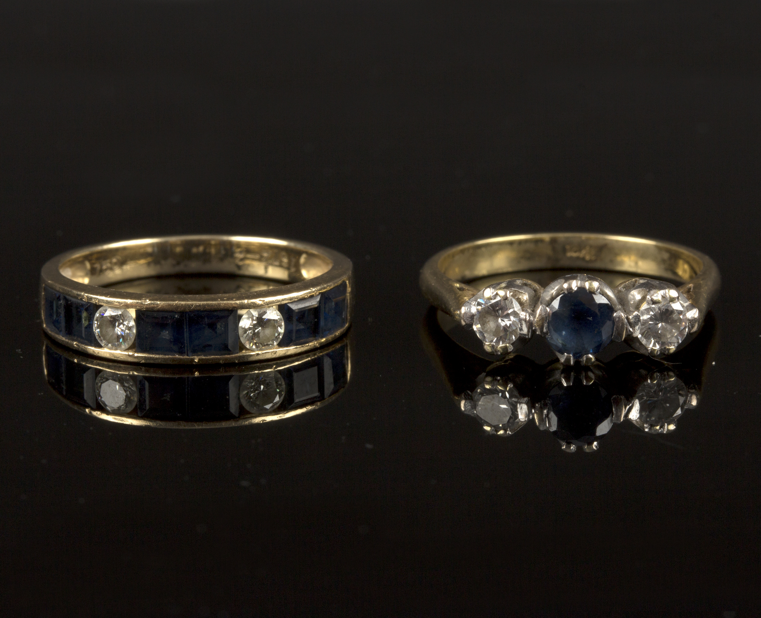 A sapphire and diamond half eternity ring to an 18ct gold shank and a sapphire and moissanite