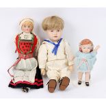 Two Continental porcelain and bisque dolls and a bisque head sailor boy doll