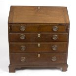 A George III oak bureau with four drawers beneath, 91.