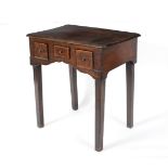 A fruitwood table fitted three drawers on square legs,