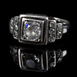 An Art Deco diamond ring, the central oval mixed cut diamond approximately 0.