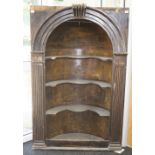 An 18th Century pine Delft cupboard of arched form, the shaped shelves flanked by fluted pilasters,