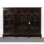 An Edwardian mahogany bookcase, fitted adjustable shelves enclosed by glazed doors, on square feet,