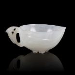 A white jade peach cup, 19th Century, carved leaves with a flowerhead base and bird handle, 8.