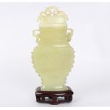 A jadeite vase and cover decorated flowers in low relief,