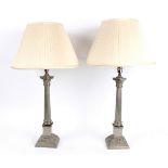 A pair of pewter lamps of Corinthian column form,