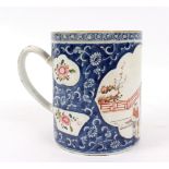 A Chinese export mug, circa 1800, decorated a panel of figures to a blue ground, 13.