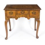 An 18th Century walnut and featherbanded lowboy, fitted three drawers on cabriole legs, 75.