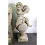 A reconstituted stone putto playing the cymbals on a socle base and square plinth,