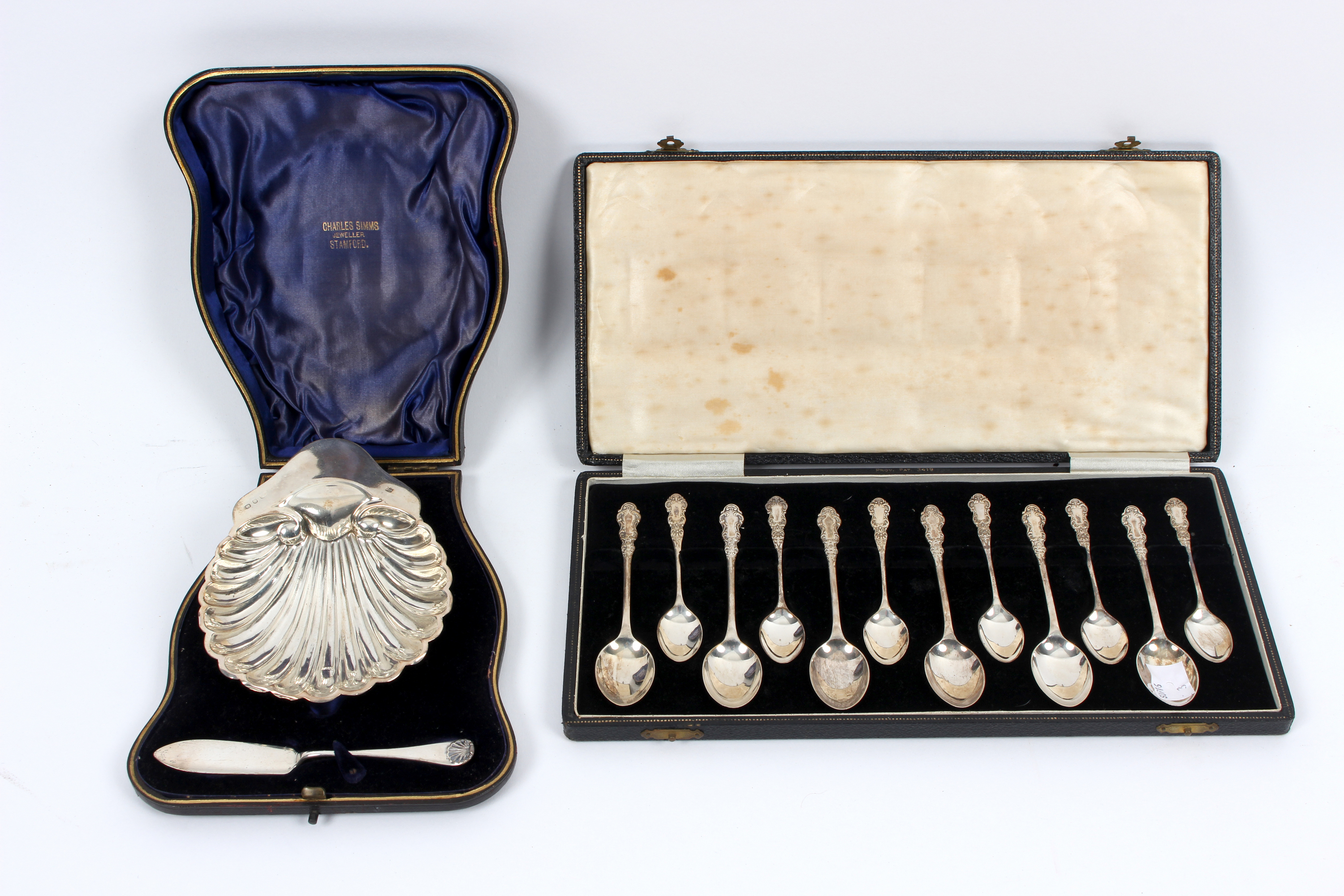 A silver butter shell, G U Birmingham 1897, the matching knife,