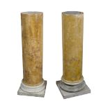 A pair of 19th Century simulated Siena marble scagliola columns, on white socle and square bases,