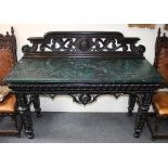 A late Victorian ebonised console table with pierced back,