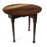 A small red walnut oval two-flap table, on round taper legs with pad feet,