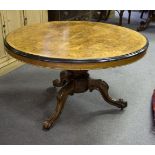 A Victorian burr walnut tilt-top table, the circular top on tripod support,