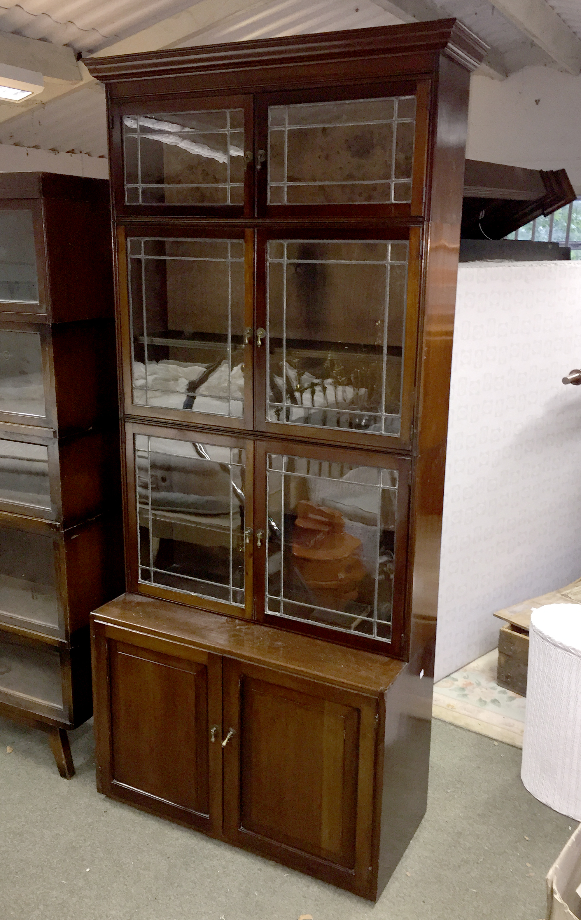 A mahogany three-section bookcase, each section enclosed by a pair of leaded doors, - Image 2 of 2