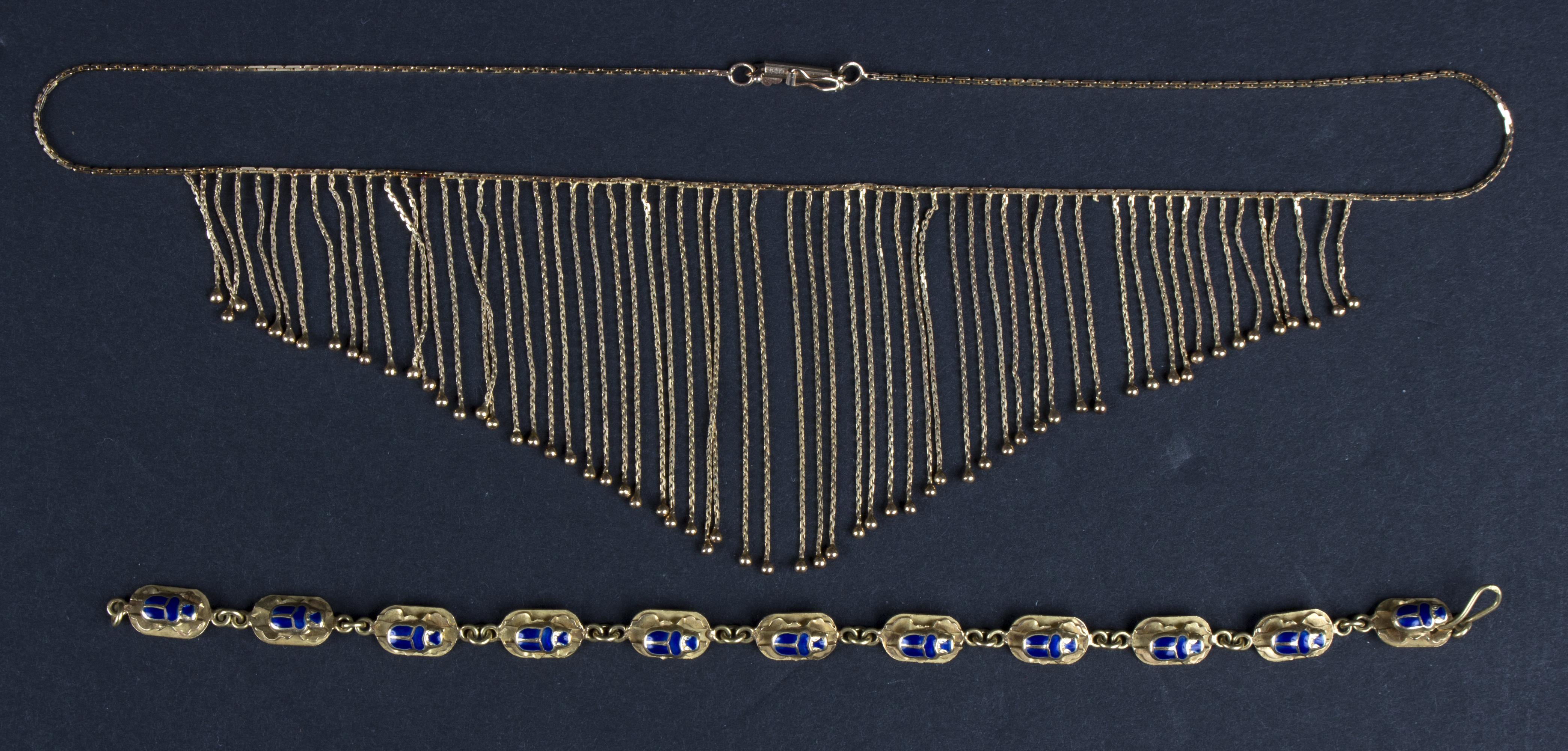 A 14K gold fringe necklace and an enamelled Egyptian scarab link bracelet,