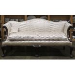 Victorian camel back sofa, having scroll decorated arms and rising on cabriole legs