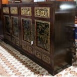 Chinese wood cabinet, fronted by two pairs of gilt lacquered doors painted with figures in