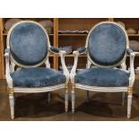 (lot of 2) Pair of balloon back armchairs, each having a white and gilt enamel painted frame with