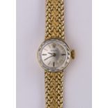 Lady's Rolex 14k yellow gold wristwatch Dial: round, silvered, sunburst, applied, gold and black