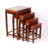 Set of four Chiense nesting tables, of graduated sizes, each with a floating top panel and an