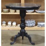 Victorian ebonized occasional table, the sculpted circular top rising on a turned standard with