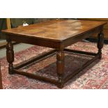 Jacobean quartersawn oak table, having a rectangular plank top above the full apron, and rising on