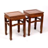 (lot of 2) Chinese hardwood stools, inset with a single floating panel, above a bead edge apron