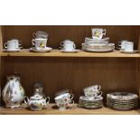 Two shelves of associated porcelain tableware, including a Bavarian floral decorated tea set with