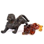 (lot of 2) Chinese sculptures of mythical beasts: the first, having a composition of amber hue