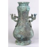 Chinese archiastic bronze hu-form lidded vessel, with a zig-zag pattern, the zoomorphic handles