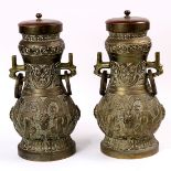 (lot of 2) Chinese archaistic brass hu-form vessels, featuring dragons in relief on a leiwen ground,