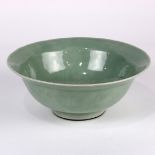 Chinese celadon glazed porcelain bowl, with an everted rim and incised pattern to the interior and