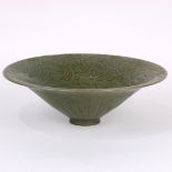 Chinese Yaozhou type celadon glazed ceramic bowl, with a conical body and wide flared rim, incised
