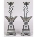 Pair of Chinese pewter candle stands, incorporating two ingots along with the characters fu and