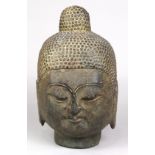 Chinese stone sculpture of a Buddha head, the serene face with down cast eyes, below the ushnisha,