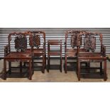 (lot of 5) Four Chinese hardwood armchairs and stand, each of the chairs carved with bats suspending