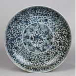 Chinese underglaze blue porcelain charger, centered by a fu-lion encircled by scrolling tendrils,