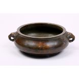 Chinese bronze censer, the low slung body flanked by elephant form handles, base marked 'Qianqing