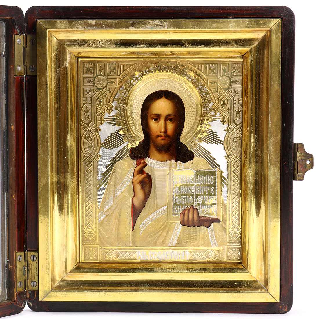 Russian hand painted icon, depicting Christ Jesus holding a book of scripture, the gilt and silvered