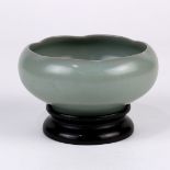 Chinese celadon glazed ceramic vessel, with a compressed body with an inverted foliate rim, molded