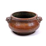 Chinese bronze censer, the compressed body flanked by a pair of lion handles, the recessed base with