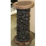 African decorative ironwood carved stool, having a circular top, above the carved standard decorated
