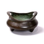 Chinese bronze tripod censer, with curved handles above the compressed body, the base marked 'Chen